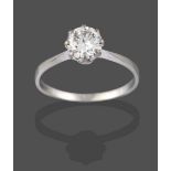 A Diamond Solitaire Ring, the round brilliant cut diamond in a white claw setting, to a tapered