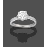 A Platinum Diamond Solitaire Ring, the round brilliant cut diamond in a four claw setting, on a