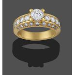 A Diamond Solitaire Ring, the round brilliant cut diamond in a yellow claw setting, to round