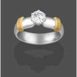 A Platinum Diamond Solitaire Ring, the round brilliant cut diamond in a claw setting, to a broad