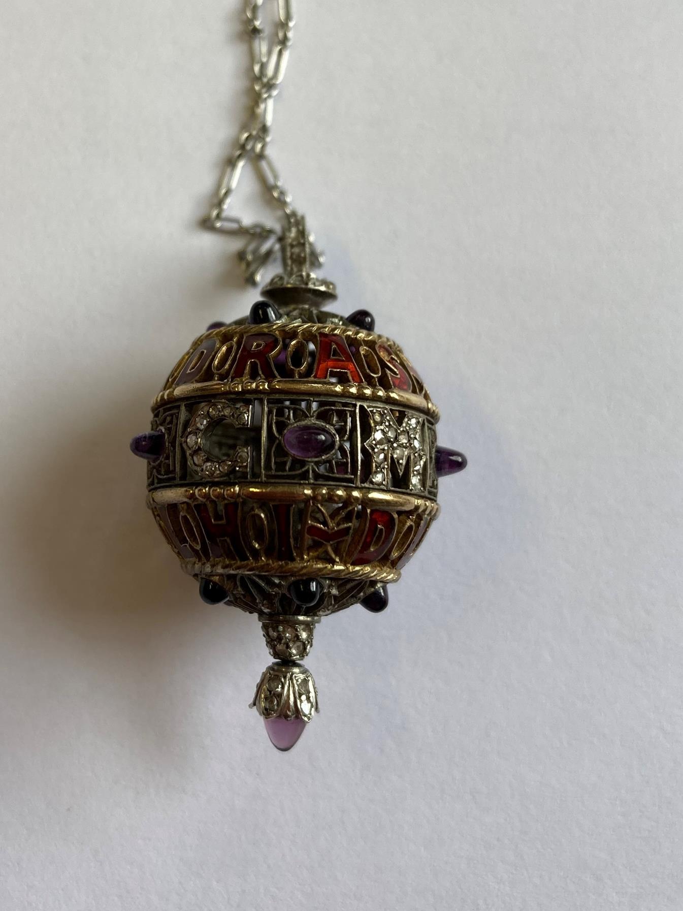 An Amethyst, Diamond and Enamel Pendant on Chain, 1911, the openwork ball with red enamel - Image 3 of 8