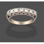 A Diamond Seven Stone Ring, the round brilliant cut diamonds in white claw settings, to a tapered