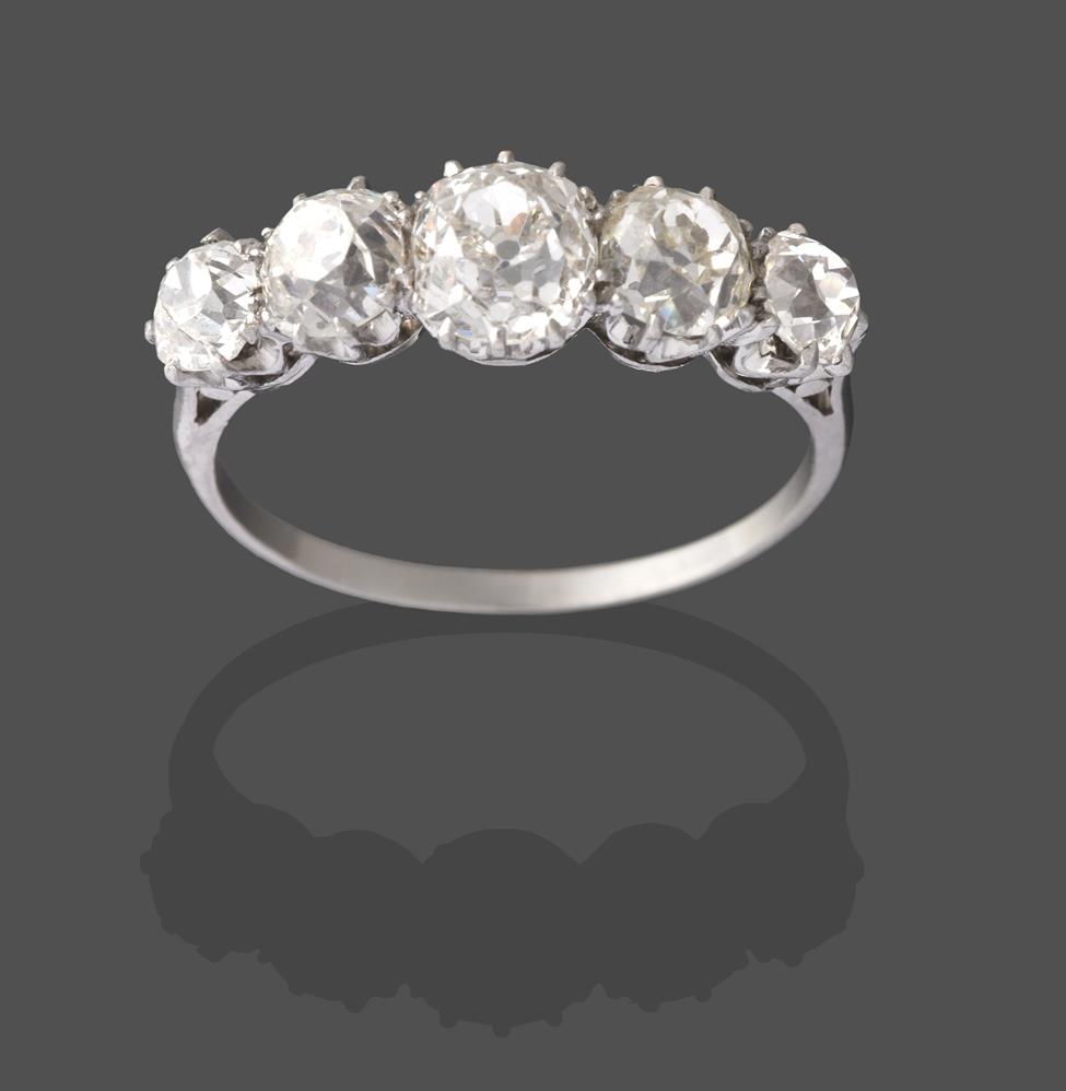 A Diamond Five Stone Ring, the graduated old cut diamonds in white claw settings, to a tapered