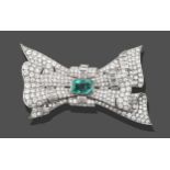 An Emerald and Diamond Brooch, stylised as a bow, with an emerald-cut emerald centrally in a white