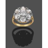 A Diamond Cluster Ring, a cushion shaped old mine cut diamond within a border of six cushion