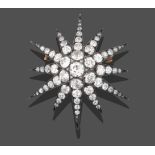 A Victorian Diamond Star Brooch/Pendant, the central raised old cut diamond with rose cut diamond
