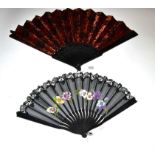 A Large Circa 1890's Black Wood Fan, the monture simply incised with a floral design, the black