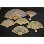 A Quantity of Celluloid Brisé Fans, the first in cream with pink and yellow roses painted in a