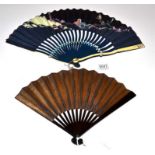 A Striking Fan, the wood sticks painted black, serpentine, the guards of shaped bone. The fan,