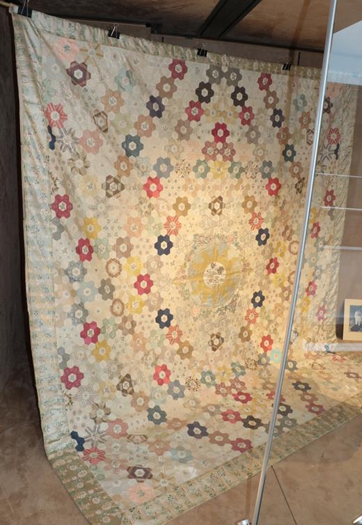 A Late 18th Century Silk Patchwork Bed Cover, with a central roundel enclosing a stylised sunburst