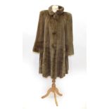 Grosvenor Canada at Harrods Long Coat, with three large fur mounted buttons, tiered panels to the