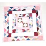Late 19th Century North Country Thrift Quilt, designed in a mosaic pattern with central square, pink
