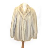 A Bradleys Creamy Grey Mink Fur Jacket, with slit pockets and dove grey leather ties to cuffs and