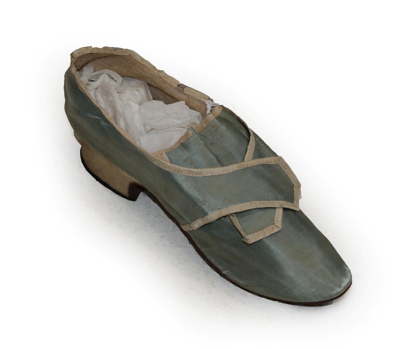 A Mid 18th Century Pale Blue Silk Single Shoe, with natural linen lining, cream silk trim and