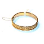 A 9 carat gold hinged bangle . Gross weight 12.3 grams.