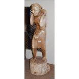 A large Sri-Lankan hardwood carving of a traditional figure, 106cm high