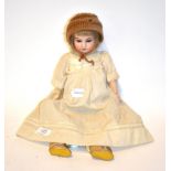 A late 19th early 20th century bisque head doll marked G K with blue glass eyes.