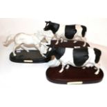 Royal Doulton Horse 'Spirit of Life' together with two Friesian cow models, on wooden plinths (3)