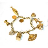 A charm bracelet with 9 carat gold padlock clasp (marks rubbed) hung with various charms including a