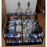 A set of ebonised and porcelain wall hanging shelves, 44cm high, various blue and white ceramics and