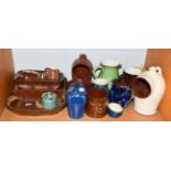 Group of slip ware pottery including bowls, salt pigs, jugs, etc (one shelf)