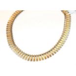 A 9 carat gold textured fringe necklace, 40cm long. Gross weight 19.75 grams.