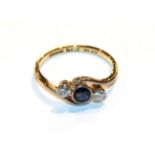 A sapphire and diamond twist ring, stamped '18CT' and 'PLAT', finger size L1/2 . The ring is in good