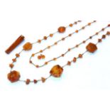 An amber bead necklace, formed of irregular shaped amber beads, length 86cm (approximately), another