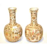 A pair of 20th Century Japanese Satsuma vases of bottle form, 31.5cm high . All over crazing to