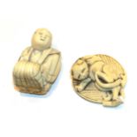 Japanese ivory netsuke, cat on a leaf, 4.5cm wide; and another as a kneeling man, 4.3cm high (2).
