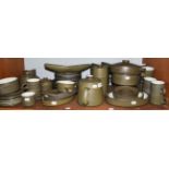 A large collection of Denby stoneware dinner and tea wares, green ground (one shelf)