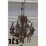 A 20th century gilt metal chandelier . One or two lustre drops lacking otherwise appears OK. Drop is