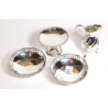 A group of silver, including: a pair of George V silver dishes, by Edward Souter Barnsley,