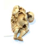 Japanese ivory netsuke, fisherman with fish and mask, 4.5cm high . Weight 15g