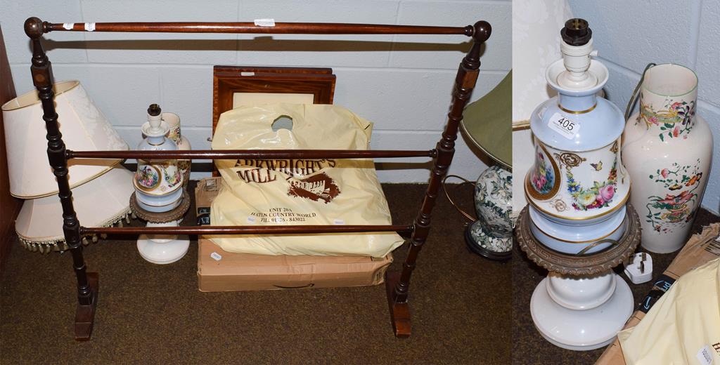 A decorative porcelain and gilt metal lamp, two mahogany and satinwood picture frames, towel rail