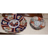 Two Japanese Imari scalloped chargers with three dishes, largest 34cm diameter (5). Several chips to