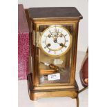 A brass four glass striking mantel clock, movement stamped S Marti, striking on a bell, with a