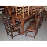 A set of eight Provincial oak dining chairs, each with urn form splats and yoke crest rails (a.