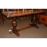 An oak refectory table, plank top with cleated ends, cup and cover supports, 167cm by 68cm by 76cm