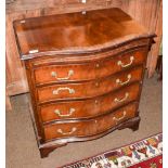 A Georgian style mahogany serpentine chest of drawers, brushing slide above four long drawers,