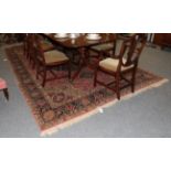 A large Middle Eastern rug, Heriz style, the central floral medallion on a salmon pink ground,