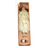 Late 19th century wax shoulder head doll, with brown wig, wax lower arms and legs on a fabric