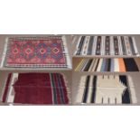 A Anatolian Kilim the field with black and white bands containing polychrome medallions framed,