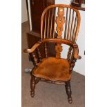 An elm Windsor chair . Split to rail with some lifting were joined