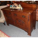 An Arts & Craft oak sideboard, carved with stylised flower and brass handles, 152cm by 54cm by