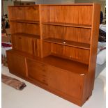 A 1970's Clausen & Son Danish teak sideboard, fitted with an arrangement of shelves, recesses,