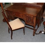 A 20th century oak desk, possibly Titchmarsh & Goodwin, 108cm by 52cm by 77cm; and an Edwardian