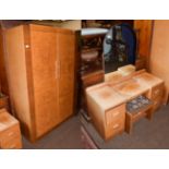 An Art Deco burr walnut veneered four-piece bedroom suite comprising, double wardrobe, single bed,