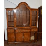 A Georgian style walnut breakfront bookcase, the central arched glazed door, flanked by two