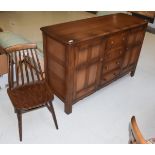 A dark elm Ercol style sideboard, 146cm by 52cm by 90cm high; together with a similar single stick-